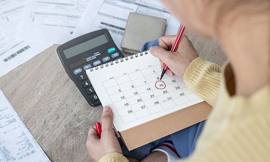 marking-a-calendar-home-accounting-bills-budgetting