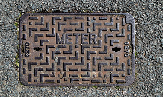 outside-water-meter-cover-on-street-sidewalk