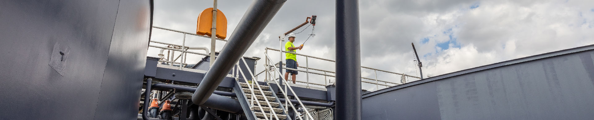 HD1920x390 Utility Worker in Large Treatment Plant